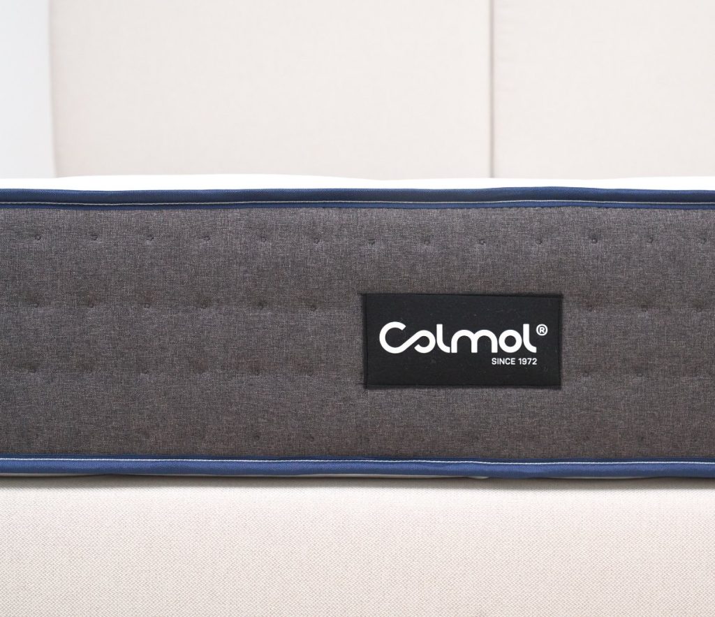 Lateral em malha cinzenta do colchão Colmol SSI Planet com etiqueta da marca