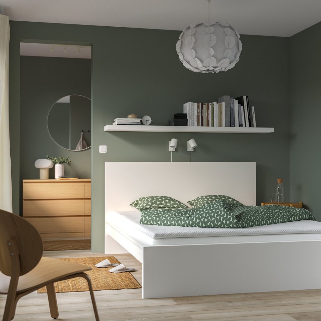 IKEA NISSEHOLM numa cama branca com roupa de cama verde num quarto